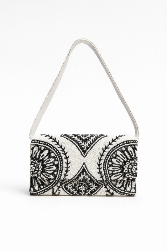 White and black Opulent Orbit hand-beaded clutch featuring luxurious circular mandala patterns and a matching beaded shoulder strap
